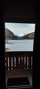 a view of a frozen lake from a window at Ferienhaus Lechtaler Alpen in Bach