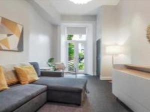 a living room with a couch and a table at Pass The Keys Main Door 3 Bed Apartment with Free Parking in Edinburgh