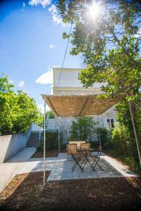a patio with a picnic table and chairs under a canopy at Apartment Victoria II in Dubrovnik