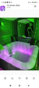 a bathroom with a tub with purple lights at LOVE ROOM Cabane des charmes in Andernos-les-Bains