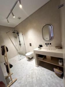 a bathroom with a sink and a shower and a toilet at RIAD LE M neuf et contemporain in Marrakech