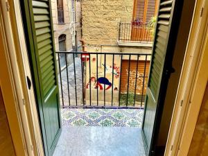 a view of a balcony from an open door at Casa Verderame in Palermo