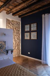 a bedroom with a bed and a blue wall at Casa Verderame in Palermo