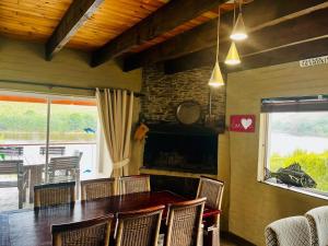 a dining room with a table and chairs and a fireplace at Malgas 168 - Kom Binne Home in Malgas