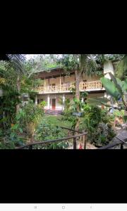 a building in the middle of a forest with trees at Happy Days Guest House in Ko Kood