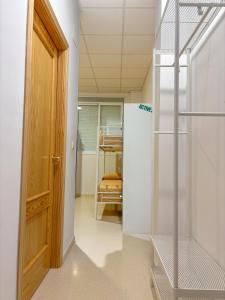 a room with a closet with a ladder and a door at Albergue Multiaventura Active Andalucia in Almodóvar del Río