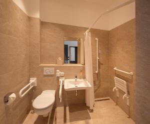 a bathroom with a toilet and a sink at MiDoma, Self Check-In Hotel, Hannover Messe in Hannover