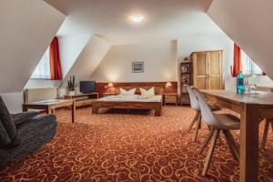 a large living room with a bed and a couch at Landhotel Lewitz Mühle in Banzkow
