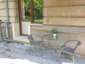 a table and two chairs in front of a building at Sea apartment / Апартамент до морето in Varna City
