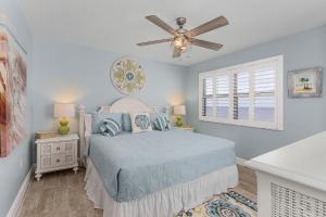 a bedroom with a bed and a ceiling fan at Beach Villas # 304 - BOGO24 condo in Fort Myers Beach
