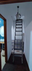 a stair case in a room with a ladder at Casa da Turquinia in Palmela
