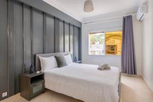 a bedroom with a large white bed and a window at TT Holidays - Rabat City Center in Rabat