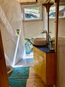 a bathroom with a sink and a window at Cabin on a Rock - Mountain Escape in Deçan