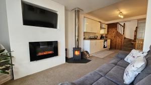a living room with a couch and a fireplace at Pepperpot in Portreath +14 photos