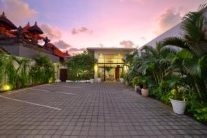 a courtyard with a tennis court in front of a building at The Luxury Collection, Monaco Blu in Seminyak