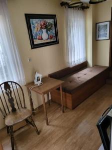 a room with a bed and a table and a chair at dar diyafa in Kreševo