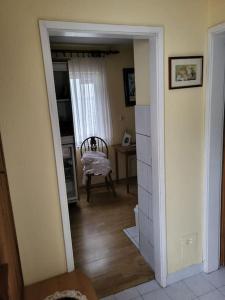 a hallway with a chair and a table in a room at dar diyafa in Kreševo