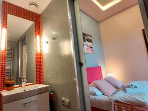 a bathroom with a shower and a sink and a mirror at Mirror Pink Studio Apartment in Krakow