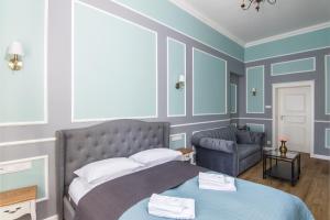 a bedroom with a bed and a couch at Karmelicka Stylish Apartments in Cracow by Renters in Krakow