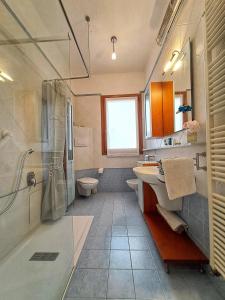 a bathroom with a shower and a sink and a toilet at Casa Mutti in Asolo