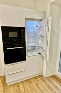 an empty refrigerator with its door open in a kitchen at Sušilova 14 apartments II in Přerov