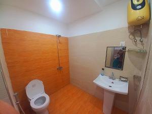 a bathroom with a white toilet and a sink at Al fazal Tower in Rāmkot