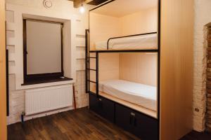 a room with two bunk beds and a mirror at Капсульний готель Добрий sleep&eat in Dnipro