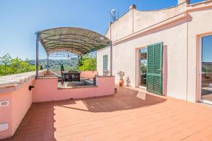 an outdoor patio of a house with a wooden deck at Casale Le Pitte in Porto Azzurro