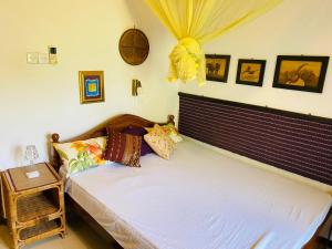 A bed or beds in a room at Ganga Villa
