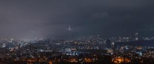a view of a city at night at Panorama Lisi Grand Hotel in Tbilisi City