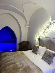 a bedroom with a large bed with a blue illumination at Zahra Superior Suite with private pool in Sannicola