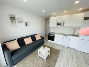 a living room with a couch and a kitchen at Apartamento Salvis Balcón in Platja d'Aro