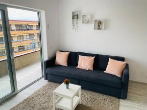 a blue couch in a living room with a window at Apartamento Salvis Balcón in Platja d'Aro
