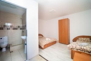 a bathroom with two beds and a sink and a toilet at Complex Route 66 in Vama Veche +152 photos