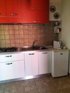 a kitchen with white cabinets and a sink at Agriturismo Nonna Luisa in Ferentino