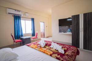 Ένα ή περισσότερα κρεβάτια σε δωμάτιο στο Hotel Nilkantha