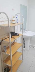 a bathroom with a shelf and a sink and a mirror at Gandan Terrace Guesthouse in Ulaanbaatar