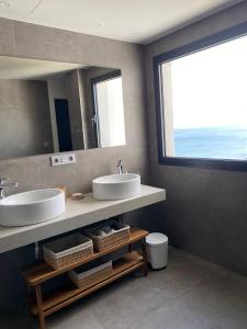 a bathroom with two sinks and a large window at Luxury duplex with sea views Blue Suite 3-303 in Manilva