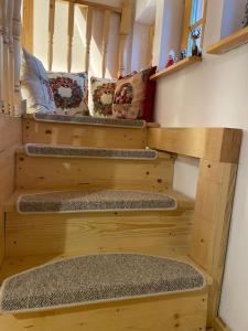 a set of three wooden stairs in a room at The Post Stana de Vale in Stana de Vale