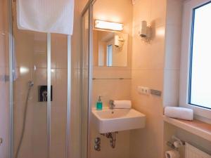 a bathroom with a shower and a sink at Gästehaus Manfred in Mittenwald