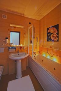 a bathroom with a sink and a shower and a tub at Hotel Picok in Ðurđevac