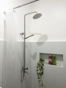 a shower in a bathroom with a shower curtain at Sunnydale Apartelle -Room Accommodation near Calatagan Beach Resorts in Batangas City