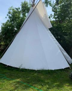 a large white tent sitting on the grass at TeePee OPPIDUM Praha-MotoFamily in Lhota