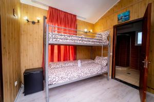 a bedroom with a bunk bed and a television at Complex Route 66 in Vama Veche