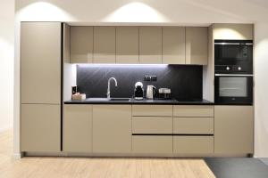a kitchen with a sink and a microwave at Solaris Apartments - free parking in Mostar