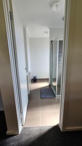 an empty hallway with a door and a mirror at Private Master Bedroom with Ensuite in Officer in Officer