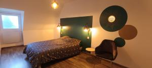 a bedroom with a bed and a mirror on the wall at Ty Mouk - proche centre ville et plages in Crozon