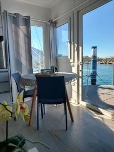 balcone con tavolo, sedie e vista sull'acqua di Floating House Anfora a Grado
