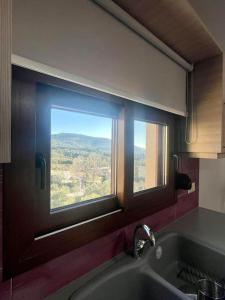 a kitchen with a window over a sink with a view at Sky view in Taxiárkhai