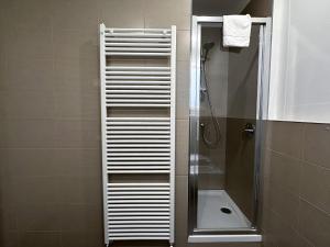 a shower in a bathroom with a glass shower stall at Ca Belverz center town apartment in Bellagio +11 photos